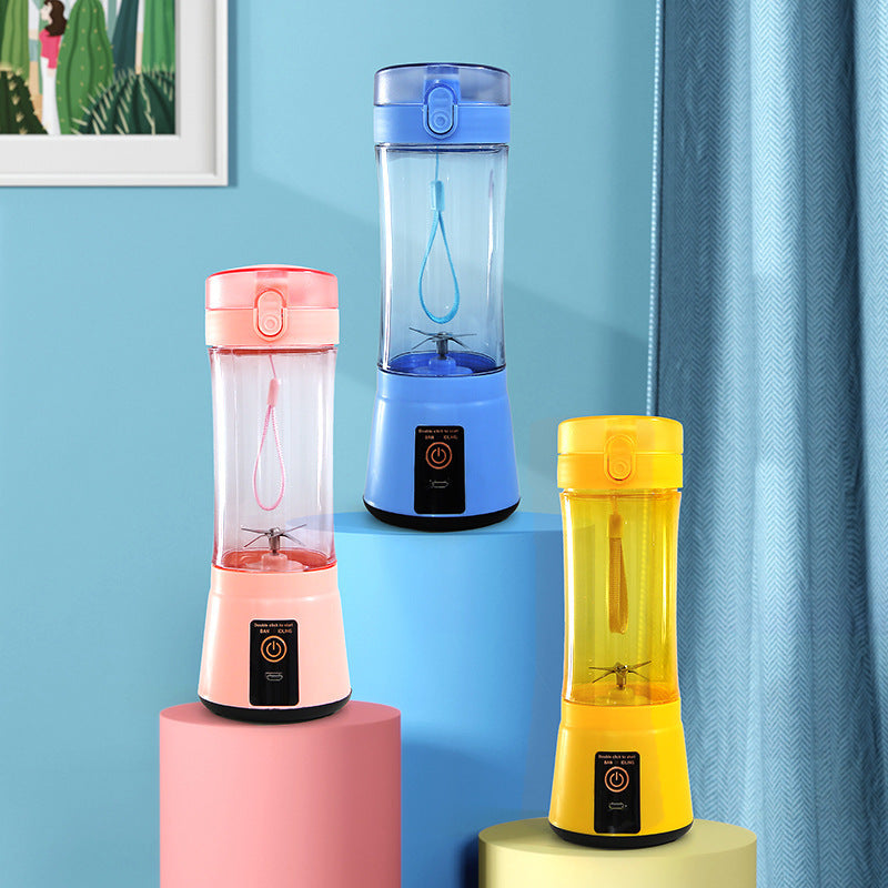 Pink, blue and yellow portable juicer blenders displayed on stand