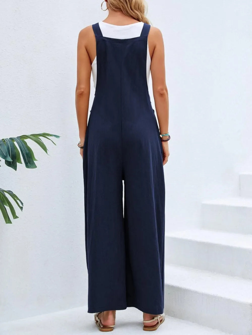 Navy square neck wide strap overalls back view on model