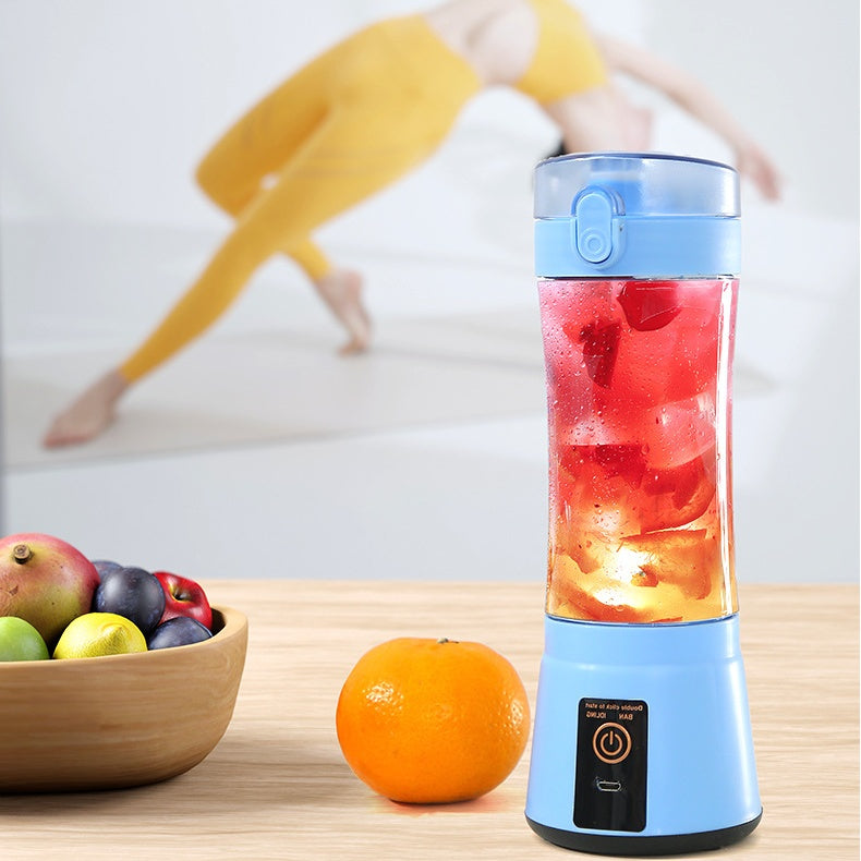 Blue portable juicer blender blending fresh fruit in action