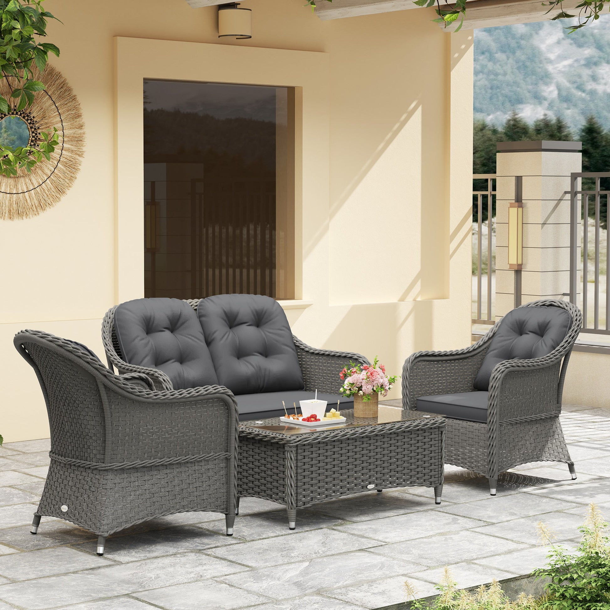 Light grey rattan sofa set with glass table displayed in garden setting