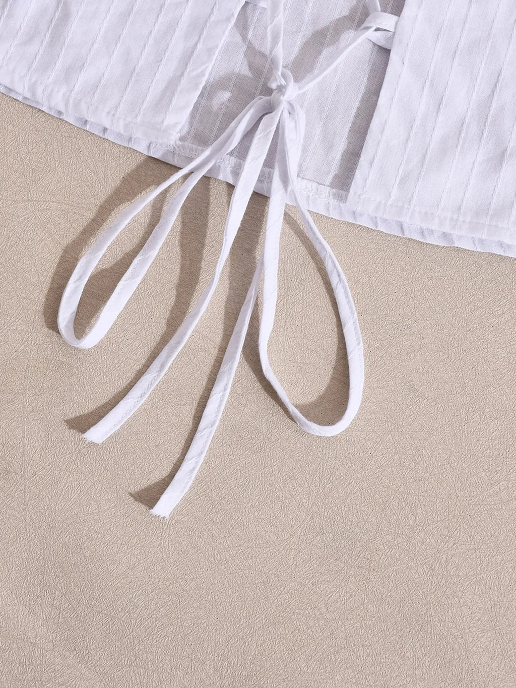 Halter neck cami top white detailed close-up bottom back knot view
