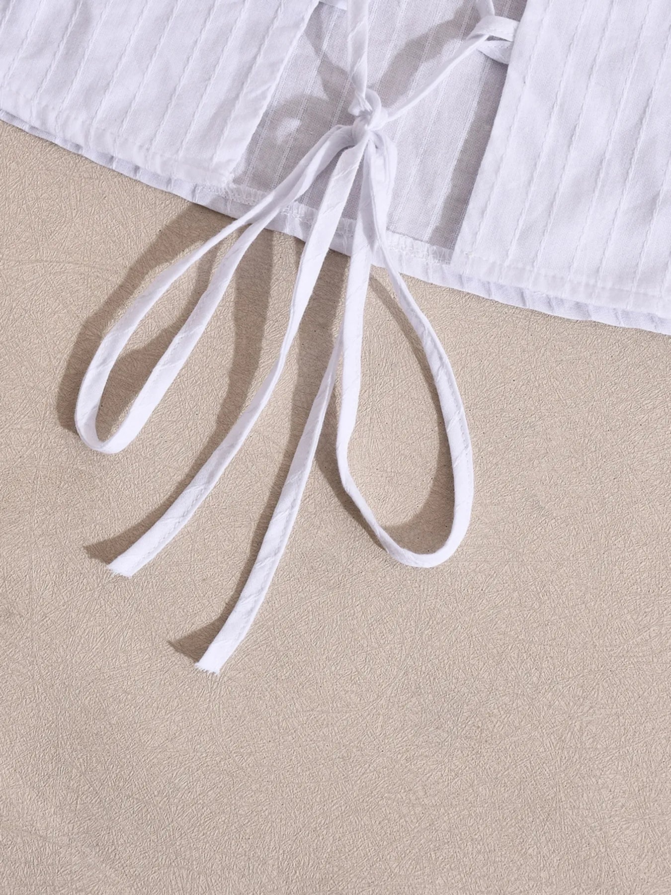 Halter neck cami top white detailed close-up bottom back knot view
