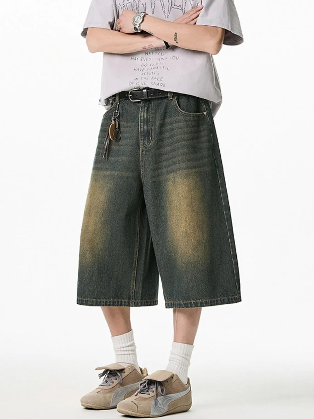 Close up front view of model wearing men's plus size washed denim pocketed shorts
