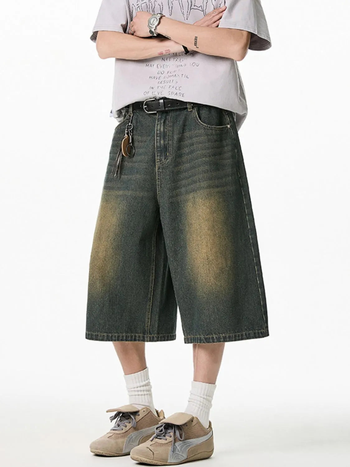 Close up front view of model wearing men's plus size washed denim pocketed shorts

