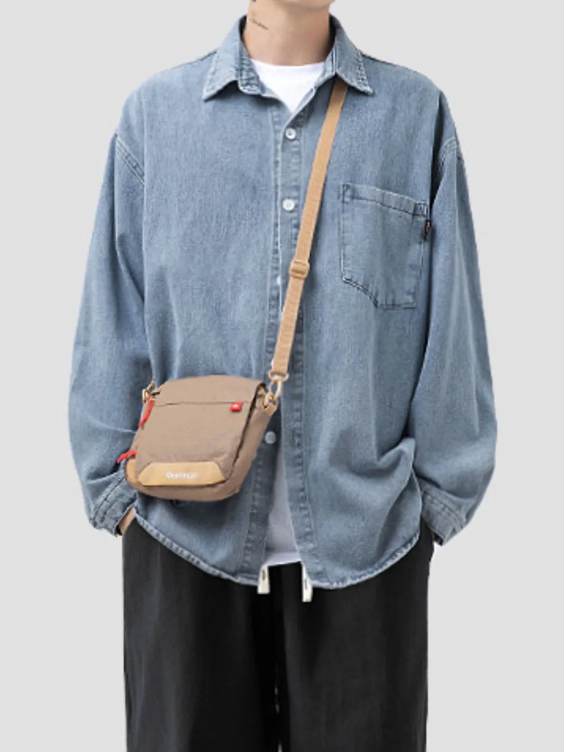 Model wearing men's plus size light blue denim long sleeve collared shirt front view
