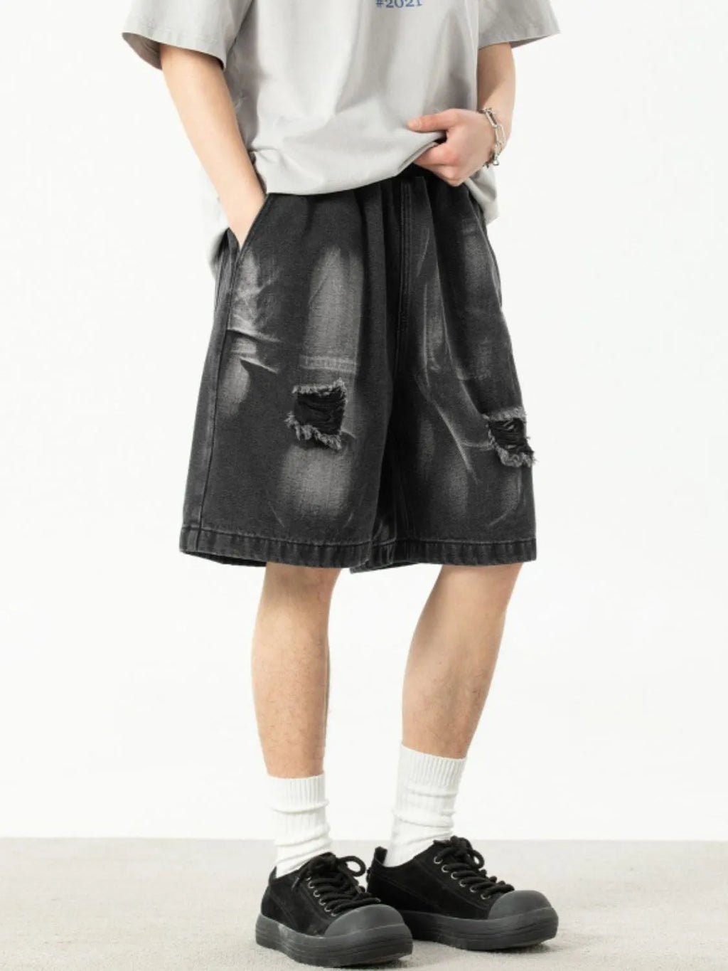 Model in men's plus size distressed denim shorts showing front and side view
