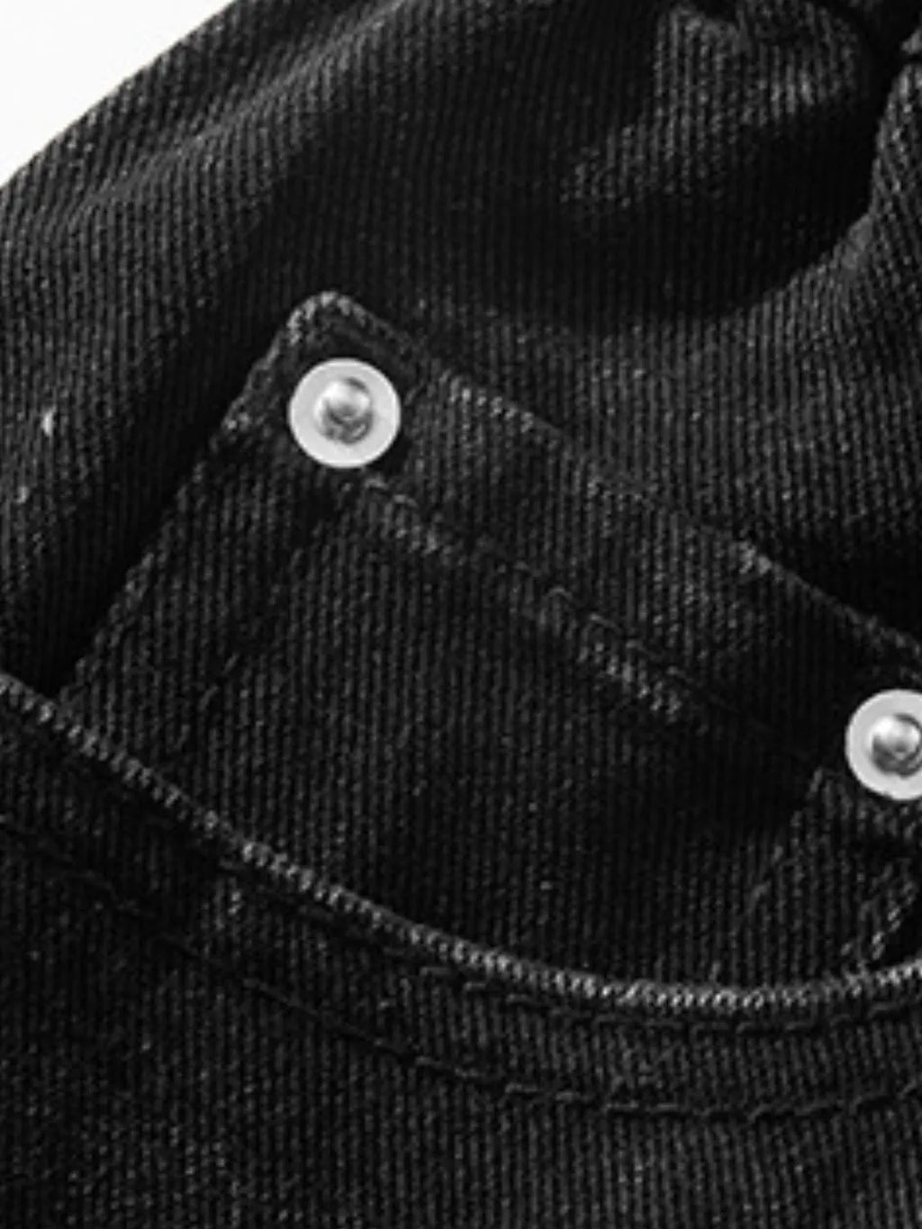 Close up material detail of men's plus size black denim pocketed shorts

