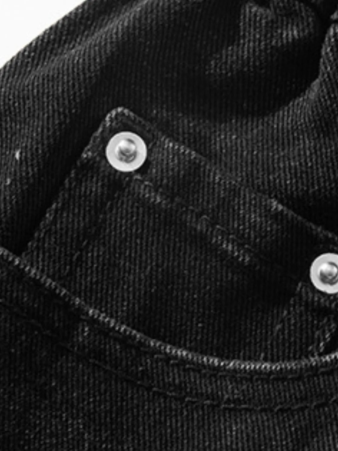 Close up material detail of men's plus size black denim pocketed shorts
