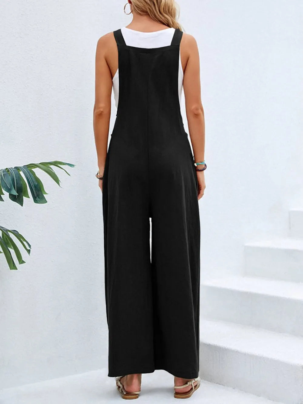 Black square neck wide strap overalls back view on model
