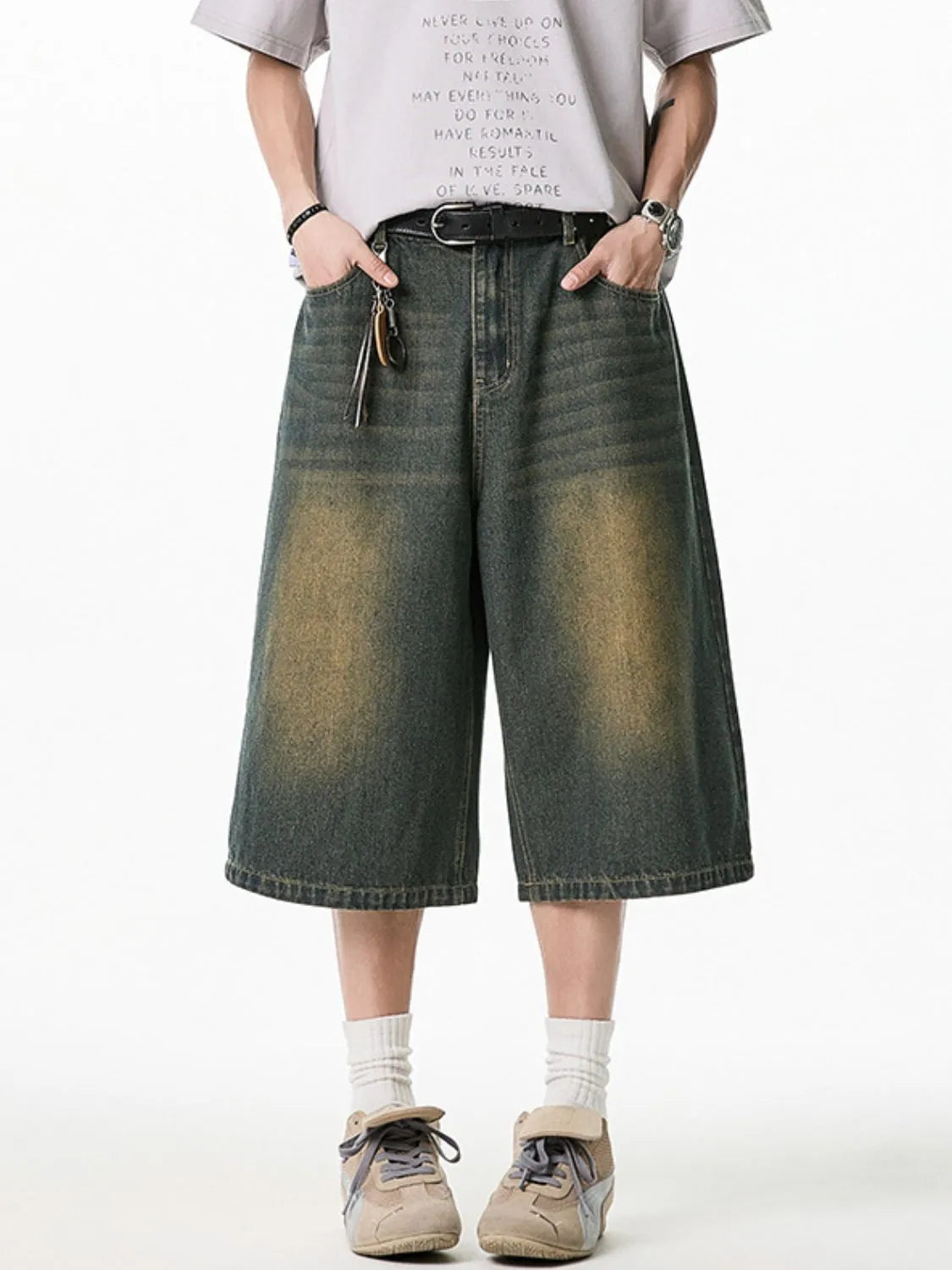 Model wearing men's plus size washed denim pocketed shorts front view
