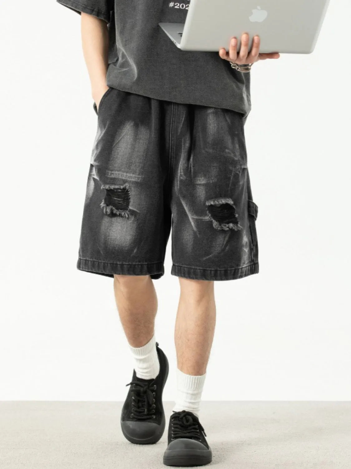 Model wearing men's plus size distressed denim shorts front view

