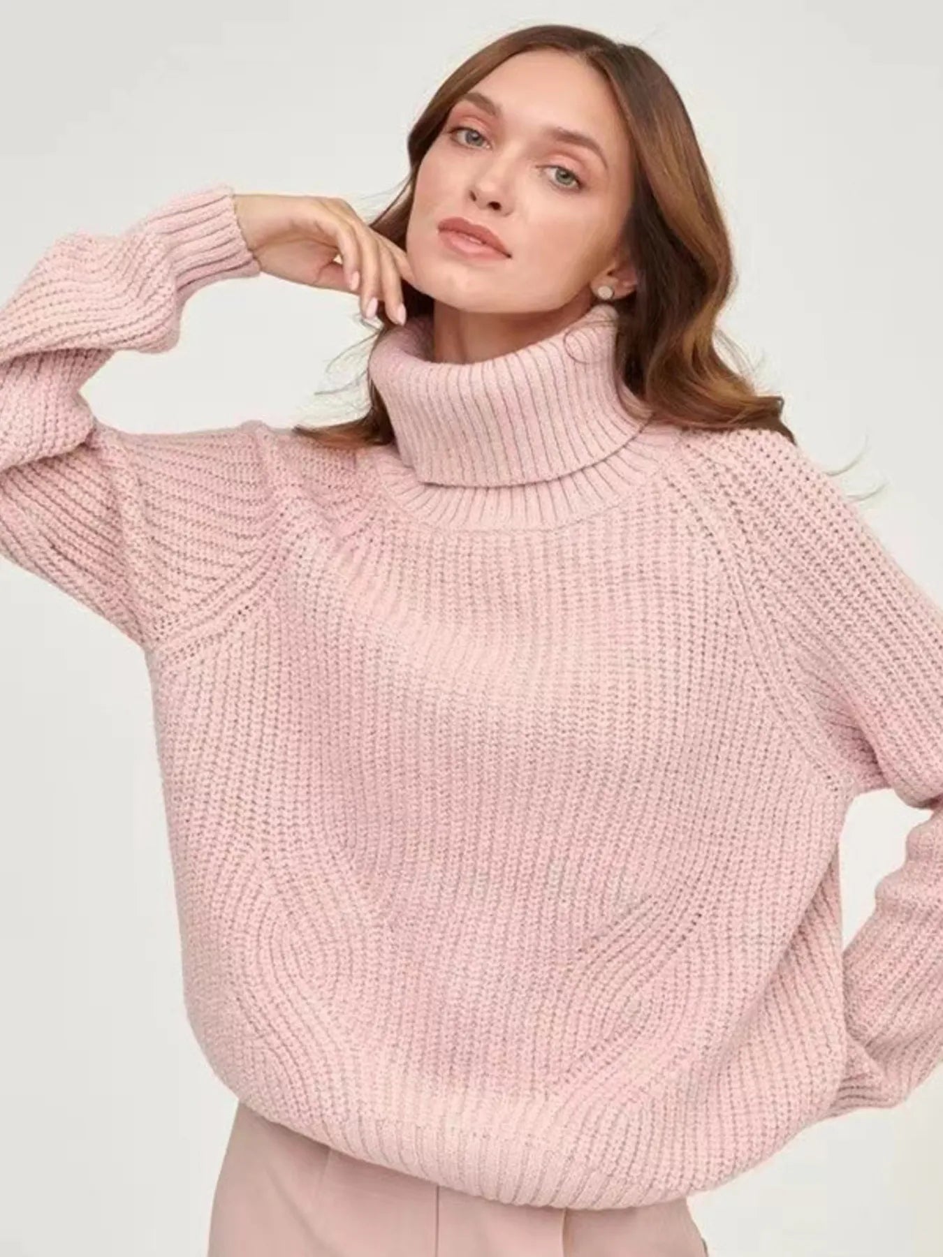 Pink oversized turtleneck long sleeve sweater front view on model