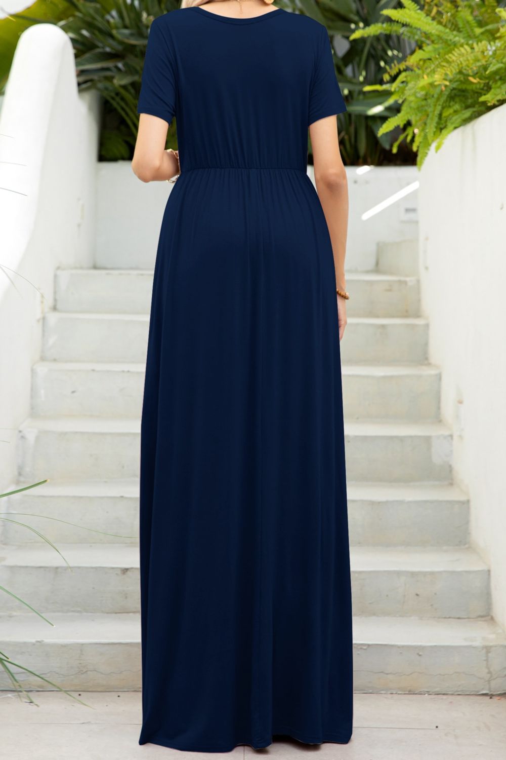 Round neck dress with pockets back view model wearing navy colourway
