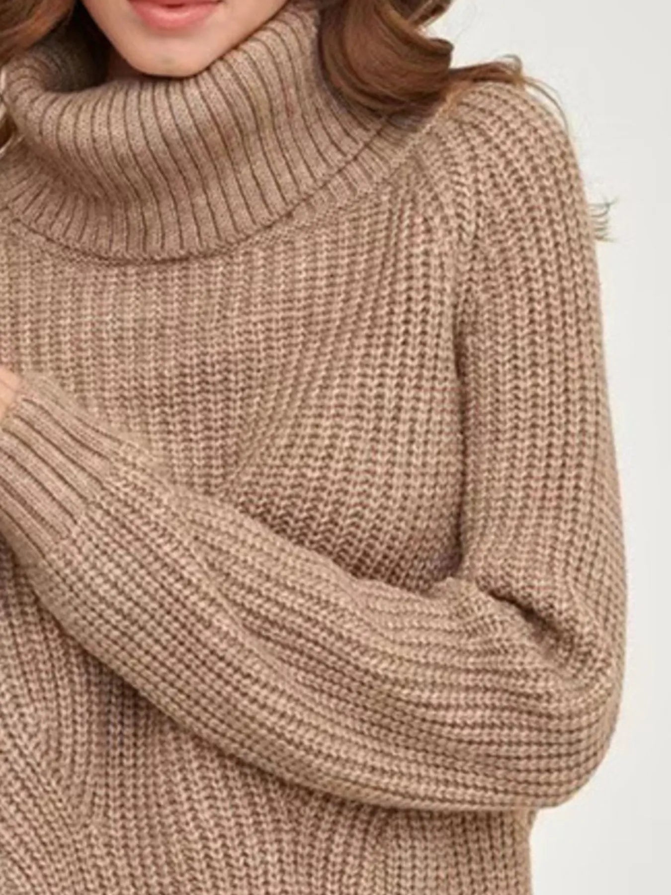 Brown oversized turtleneck long sleeve sweater material close-up on model