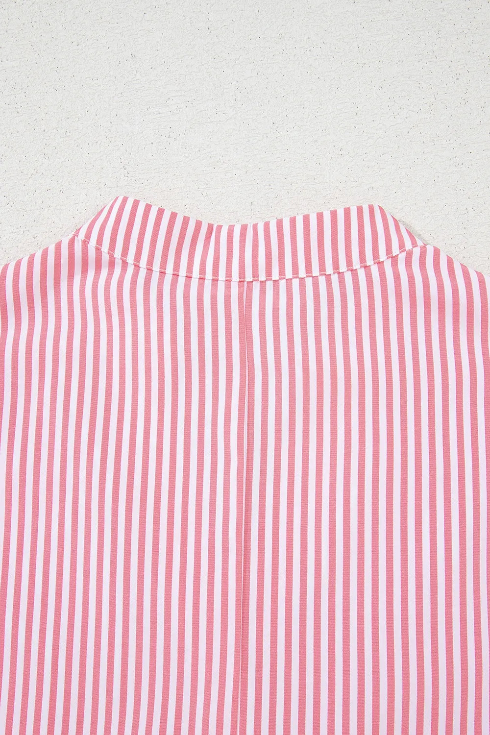 Close-up of stripe blouse back collar construction
