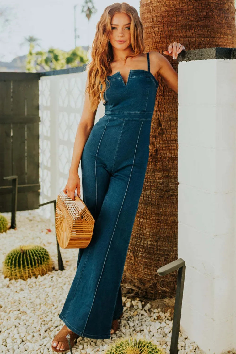Wide leg denim jumpsuit full front view showing complete silhouette

