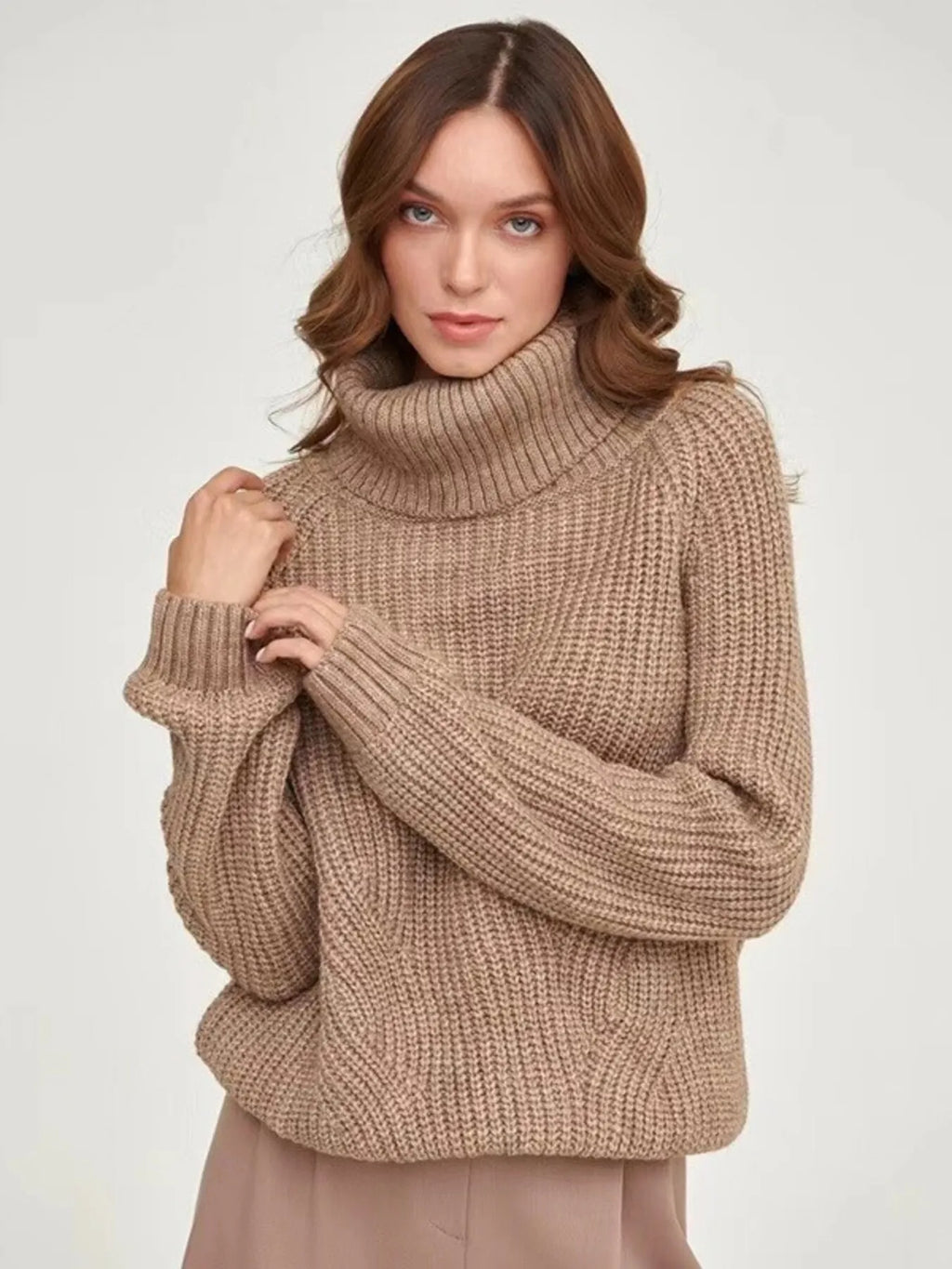 Brown oversized turtleneck long sleeve sweater front view on model