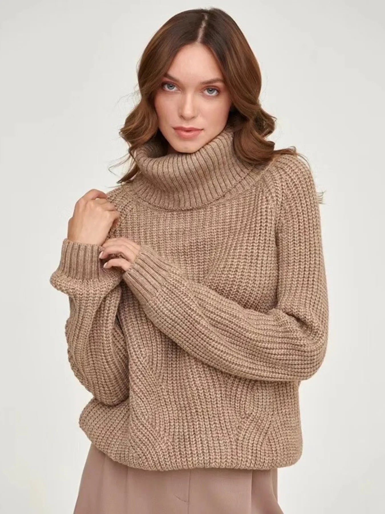 Brown oversized turtleneck long sleeve sweater front view on model