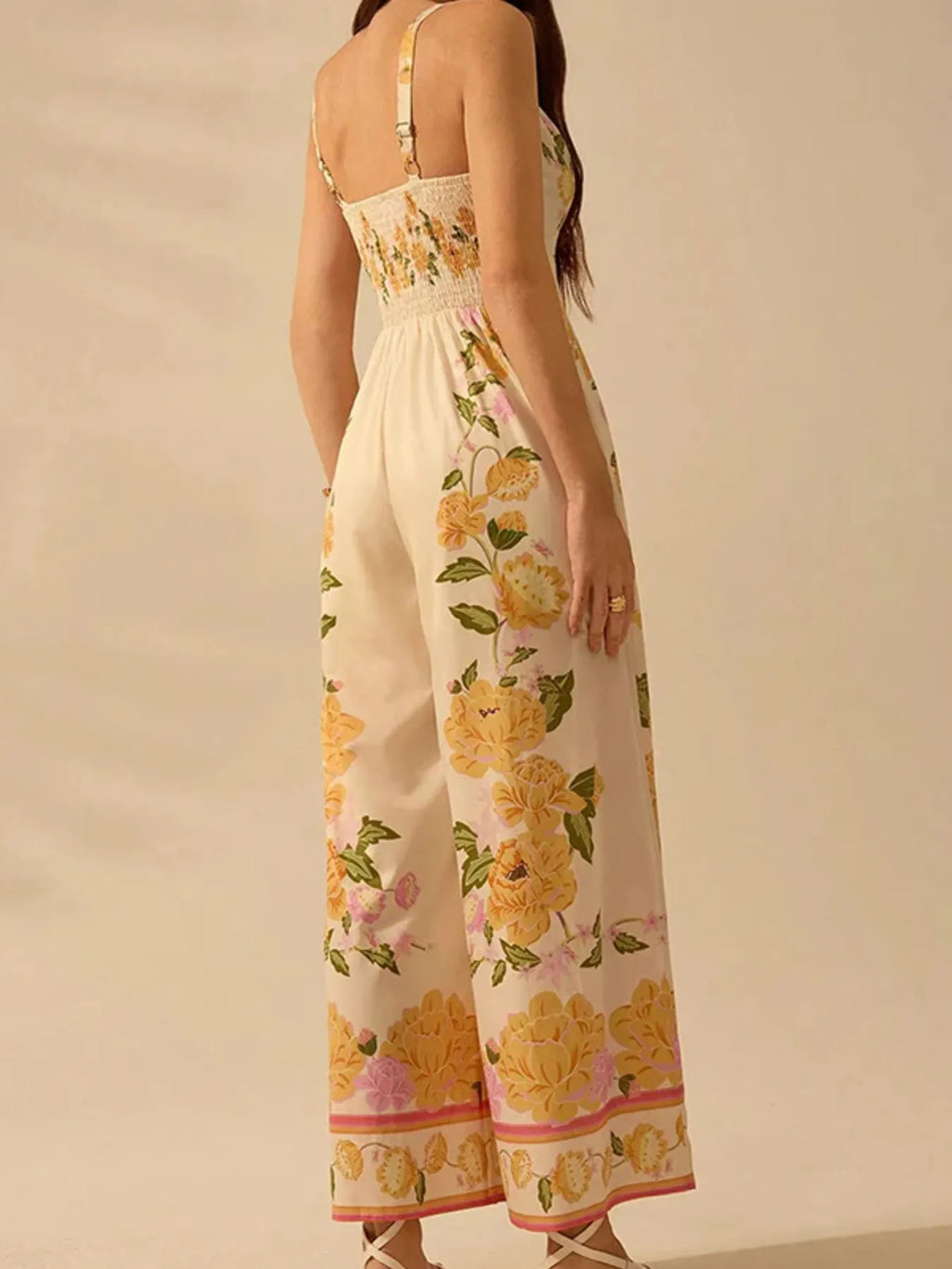 Model in floral print wide-leg V-neck cami jumpsuit showing back and side view
