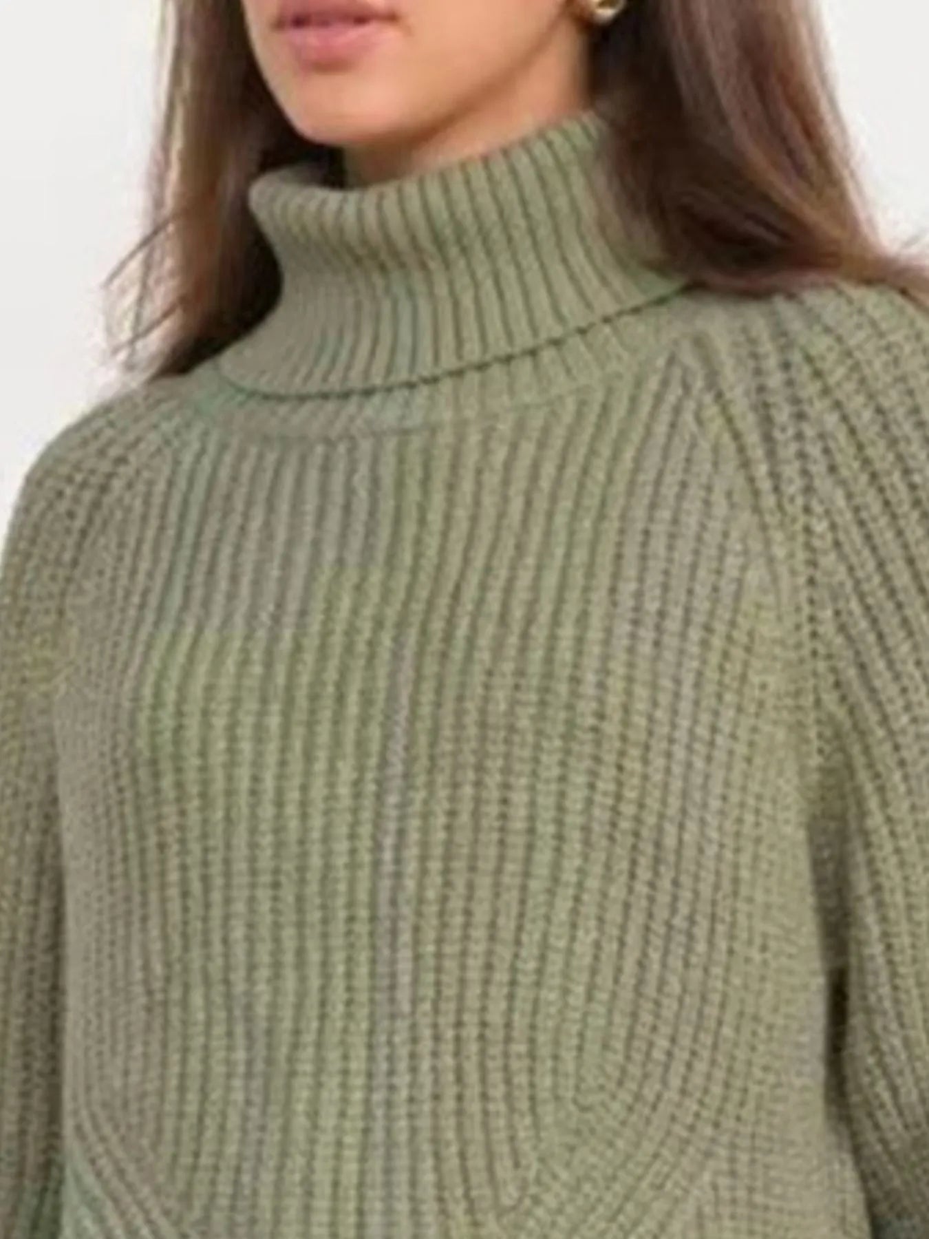 Green oversized turtleneck long sleeve sweater collar close-up on model