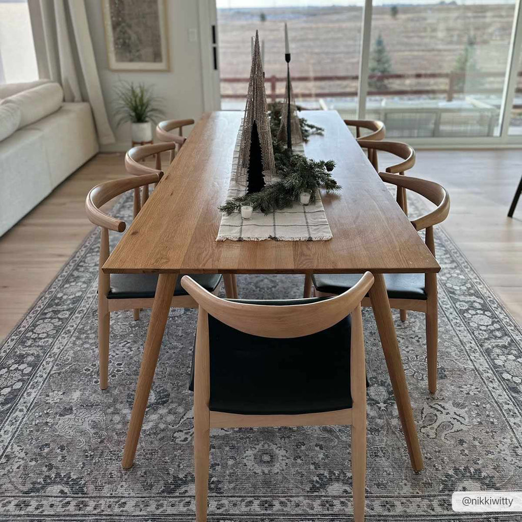 Large Ganyangan washable rug displayed under long dining table home decor
