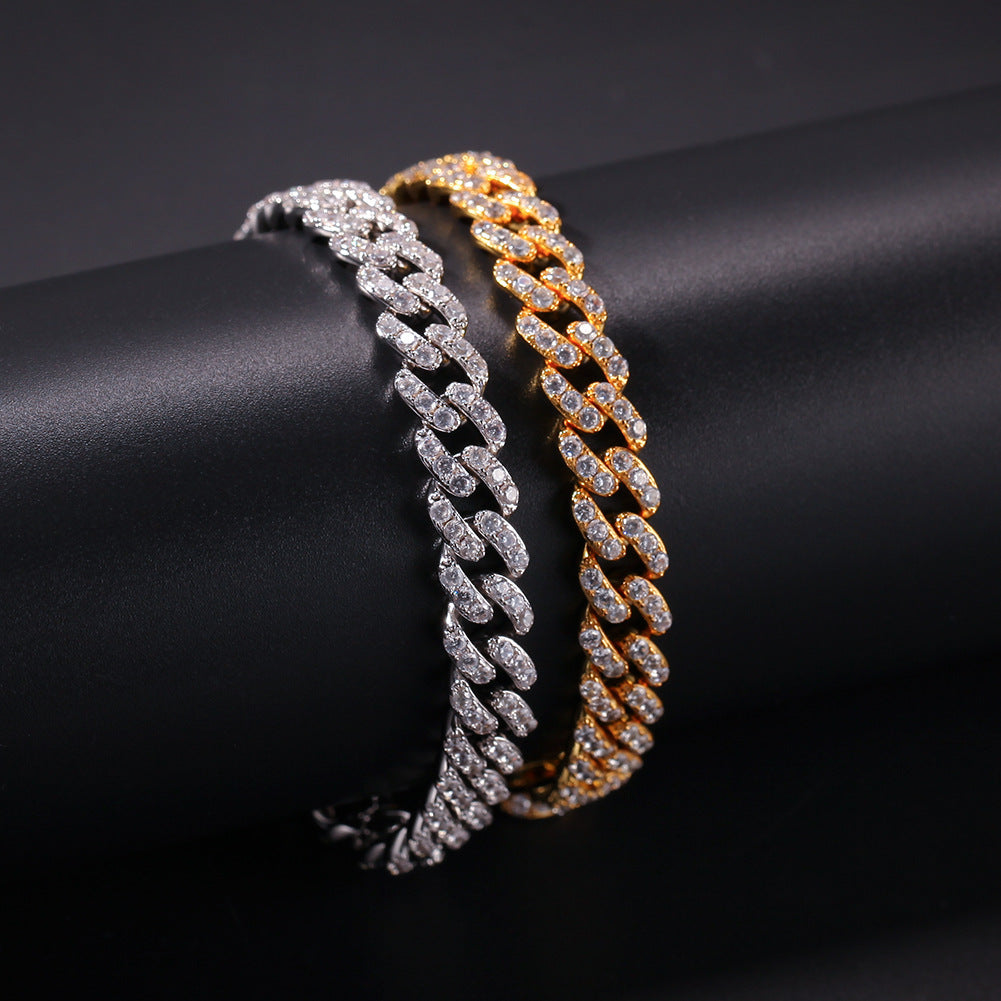 Gold and silver Cuban chain necklace wrapped around cylinder display
