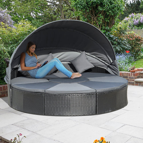 Detailed front view of black PE rattan outdoor daybed set with cushions

