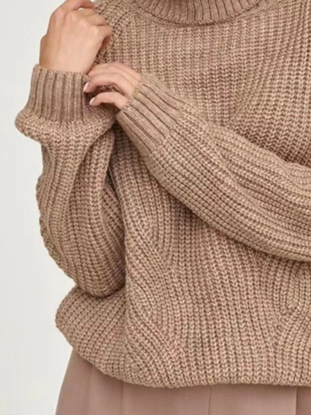 Brown oversized turtleneck long sleeve sweater sleeve close-up on model 
