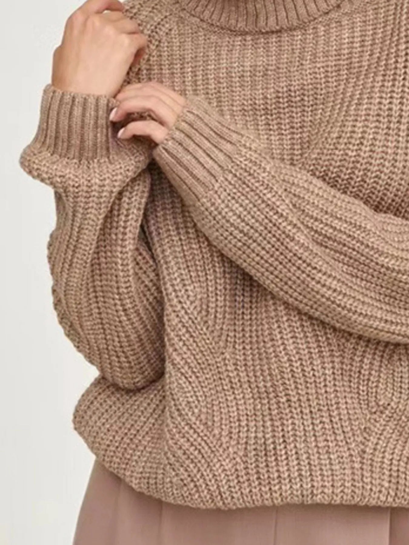 Brown oversized turtleneck long sleeve sweater sleeve close-up on model 
