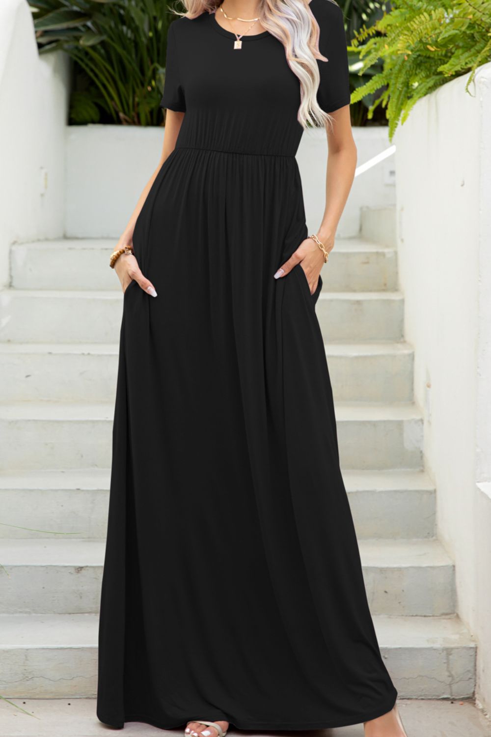 Round neck dress with pockets front view model wearing black colourway 
