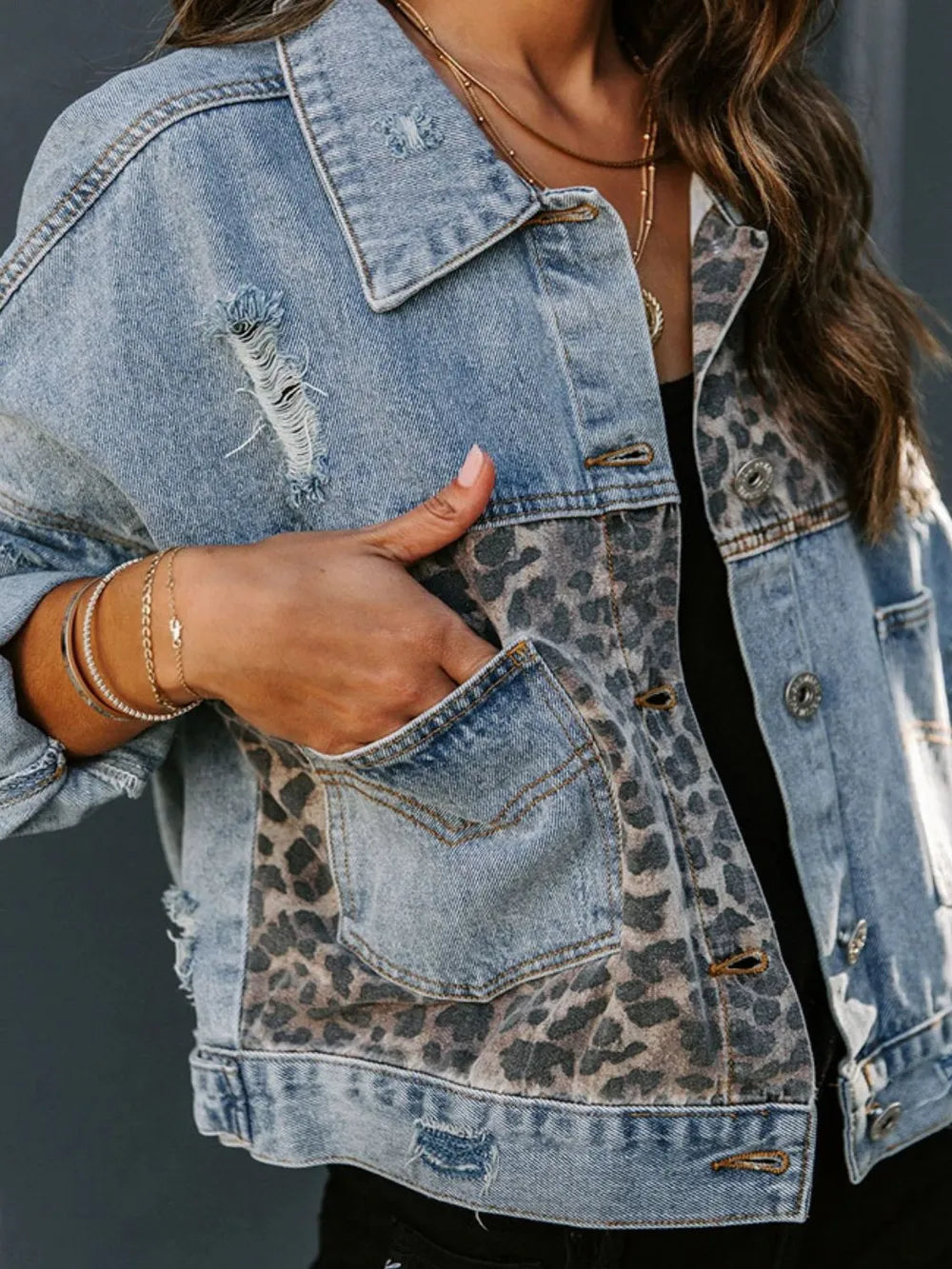 Close-up of leopard print pattern and distressed denim details
