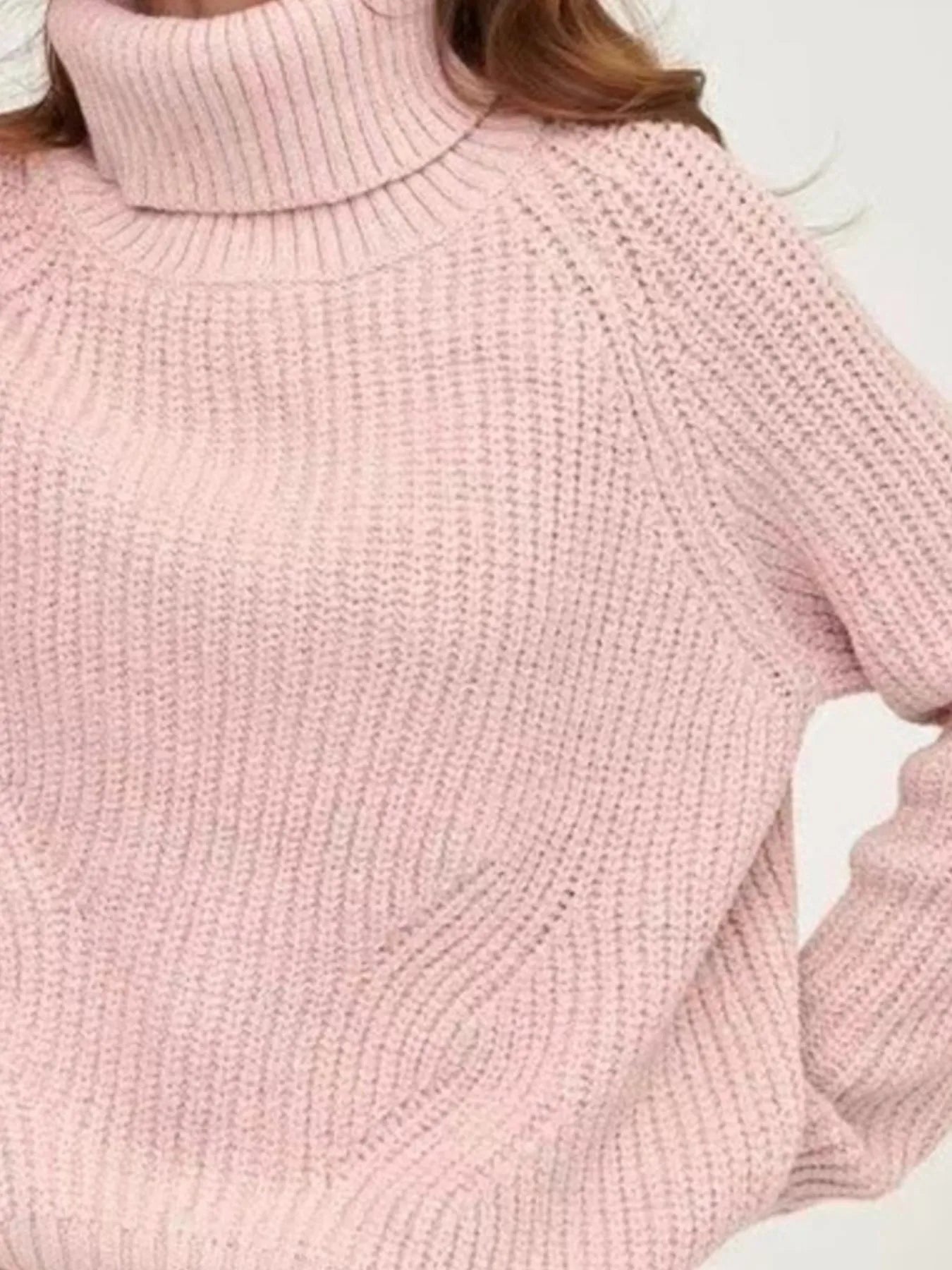 Pink oversized turtleneck long sleeve sweater collar and material close-up on model